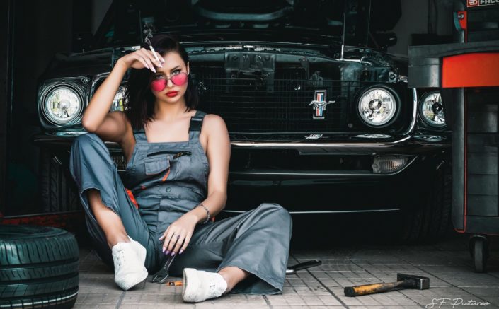 sexy mechanic girl Katerina posing on the floor with mustang car