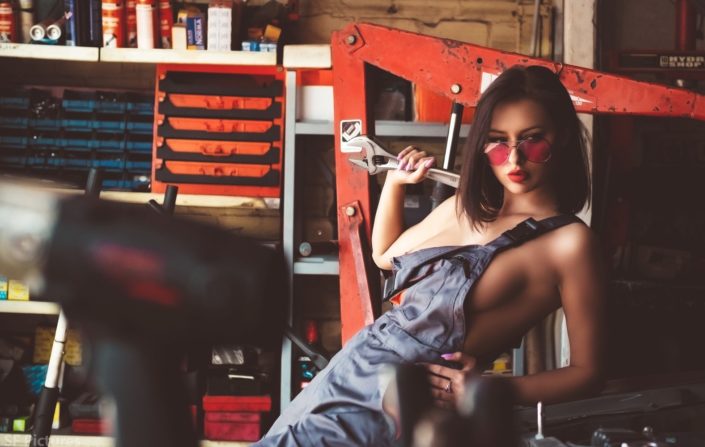 Stunning girl Katerina as a mechanic girl posing in the garage topless