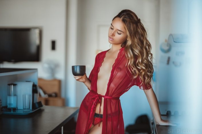 super model Nellya in red in the kitchen by fred photographe boudoir Paris